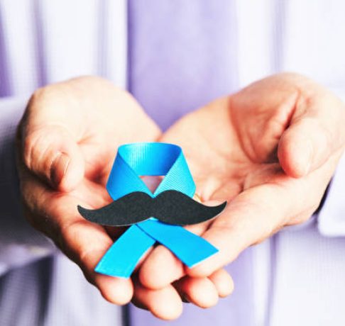 Male hands holding prostate cancer awareness ribbon with mustache