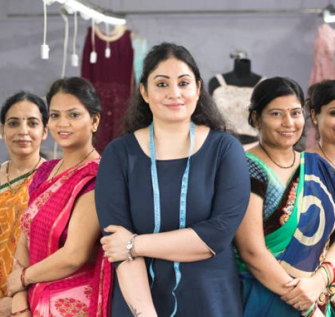 Female textile workers standing together in solidarity at factory